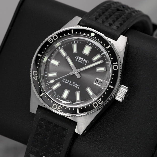 Seiko Automatic Diver's 200m watch with black dial, luminous markers, and textured rubber strap on display